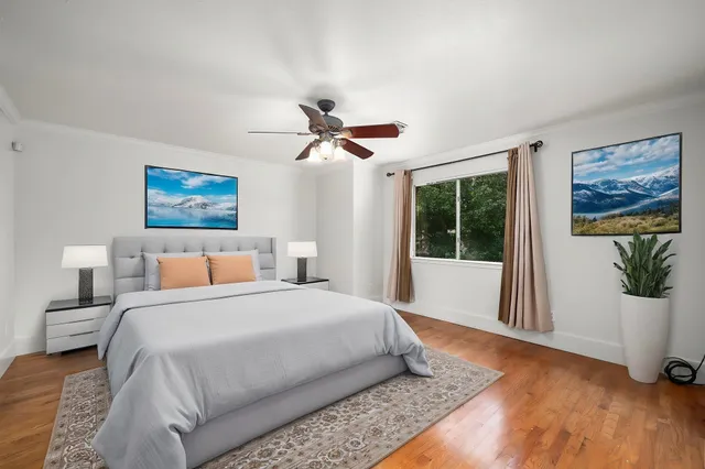 a bedroom with a large bed and a large window