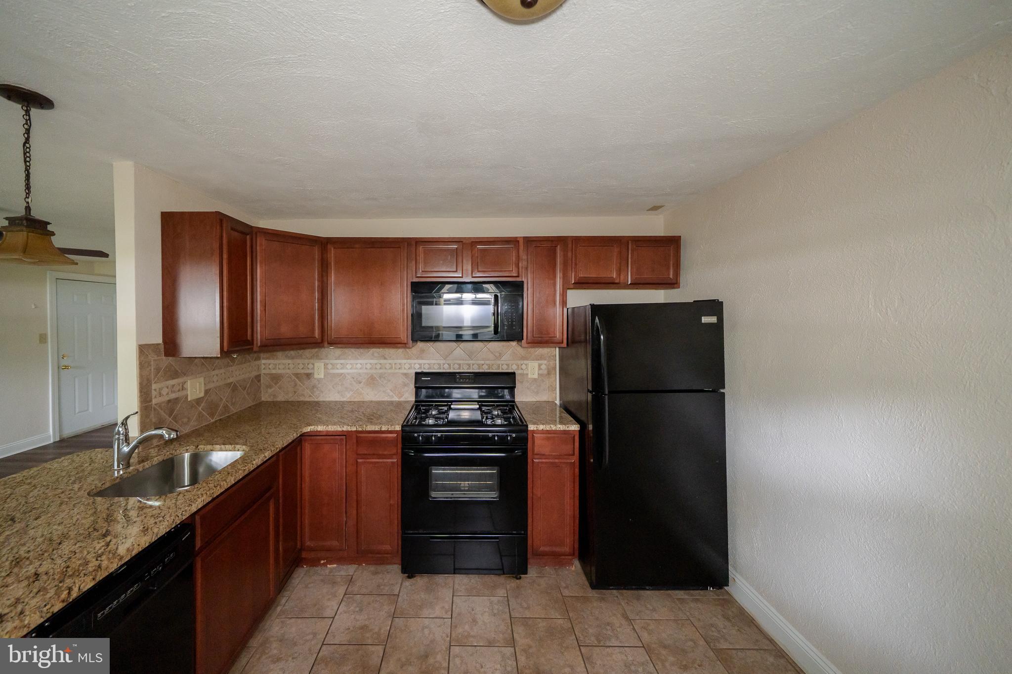 231 Sharpless Street, Unit 1D West Chester, PA 19382 - Photo 3 of 11 a kitchen with a refrigerator and a sink