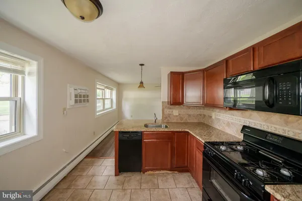 a kitchen with granite countertop a stove and a sink