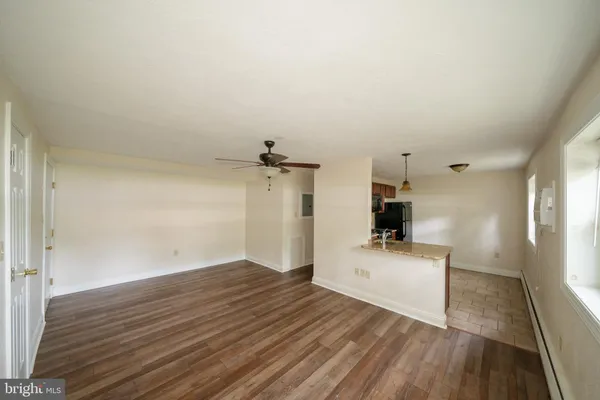 a view of empty room with wooden floor