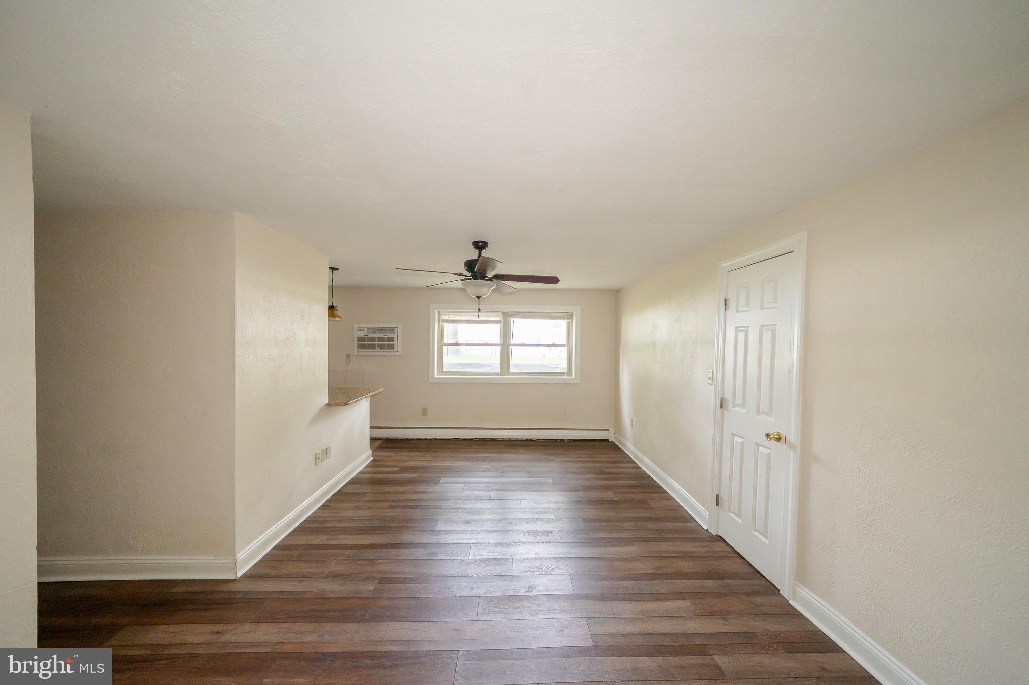 231 Sharpless Street, Unit 1D West Chester, PA 19382 - Photo 6 of 11 wooden floor in an empty room with a window