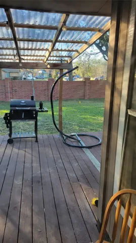 a view of yard with green space and wooden fence
