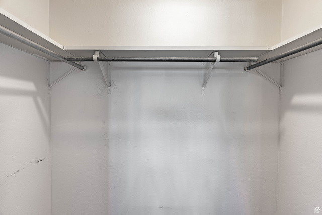 728 400 East Orem, UT 84097 - Photo 22 of 30 White shelving system with metal hanging rods