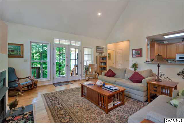 10 North Ridge Way Stanardsville, VA 22973 - Photo 8 of 25 Another view of the living/great room with a peak into the kitchen area and a glimpse of the side deck through the French doors.