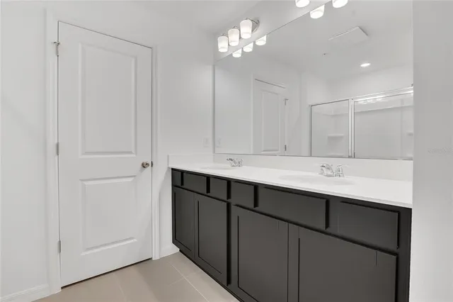 a bathroom with a sink vanity and a mirror