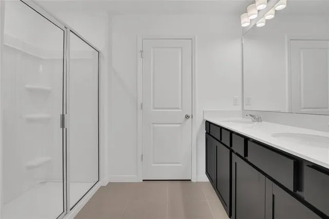 a bathroom with a sink vanity and a mirror
