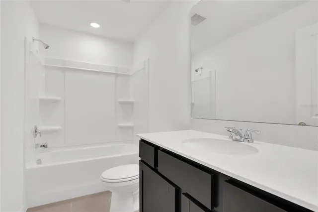 a bathroom with a sink a toilet and a bathtub