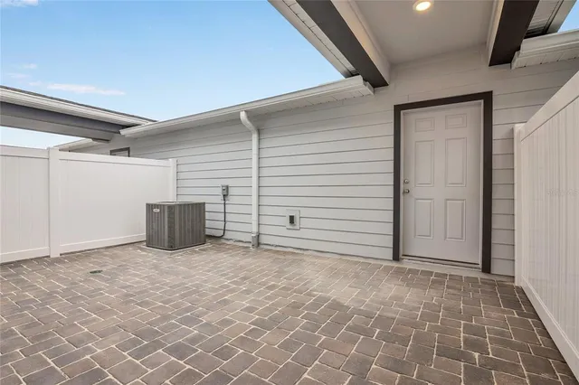 a view of an empty room with wooden door