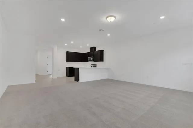 a view of a kitchen with a sink and white wall