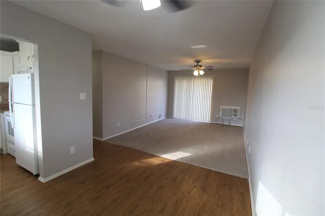 a view of a livingroom with a ceiling fan and window
