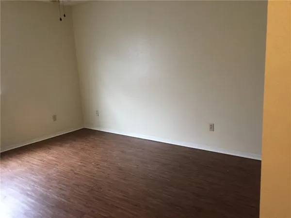 a view of an empty room and wooden floor