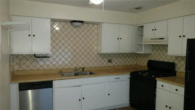 a kitchen with a sink and cabinets