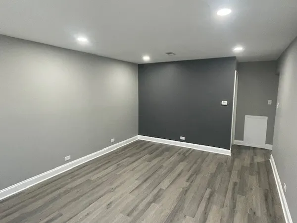 a view of room with wooden floor
