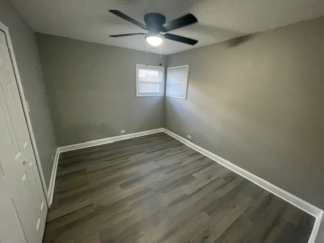 417 Hickory Street, Unit 2 Chicago Heights, IL 60411 - Photo 5 of 8 an empty room with wooden floor and windows