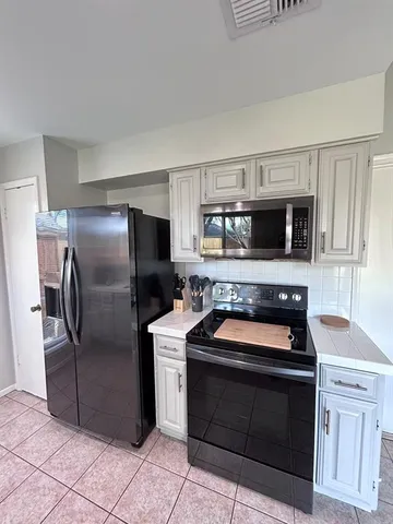 a kitchen with a stove microwave and refrigerator