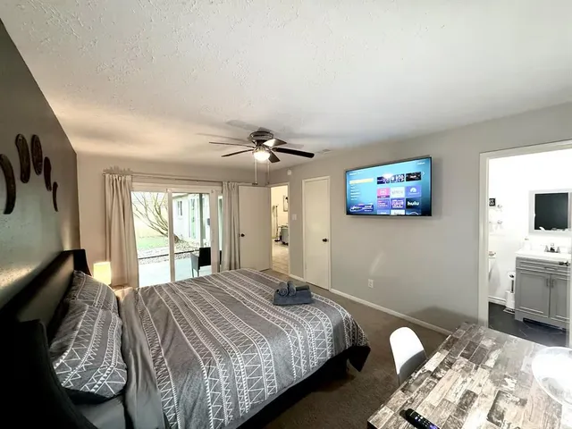 a bedroom with bed and window