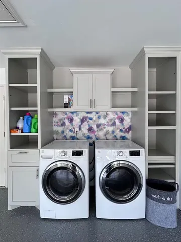 a utility room with sink dryer and washer