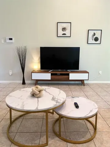 a work room with furniture and a flat screen tv