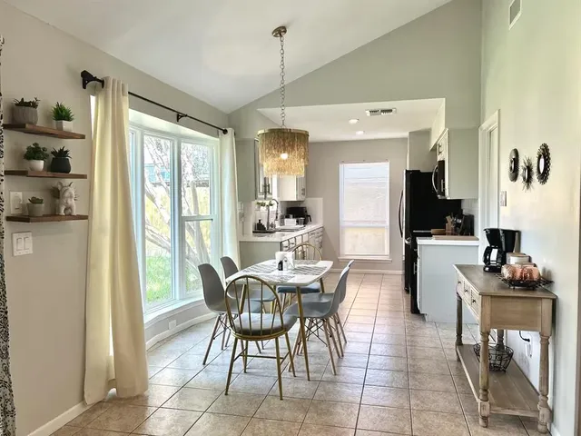 a dining room with furniture and window