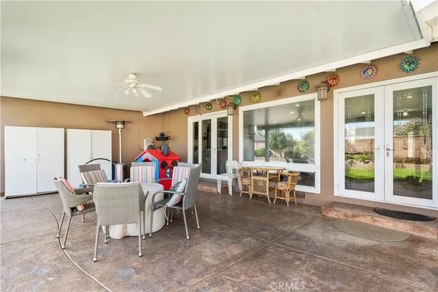 a view of a dining room with furniture chandelier and glass door