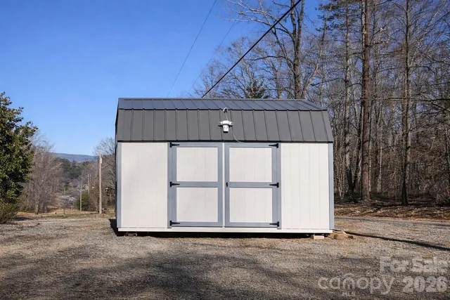 a view of a house with a yard covered with snow in front of house