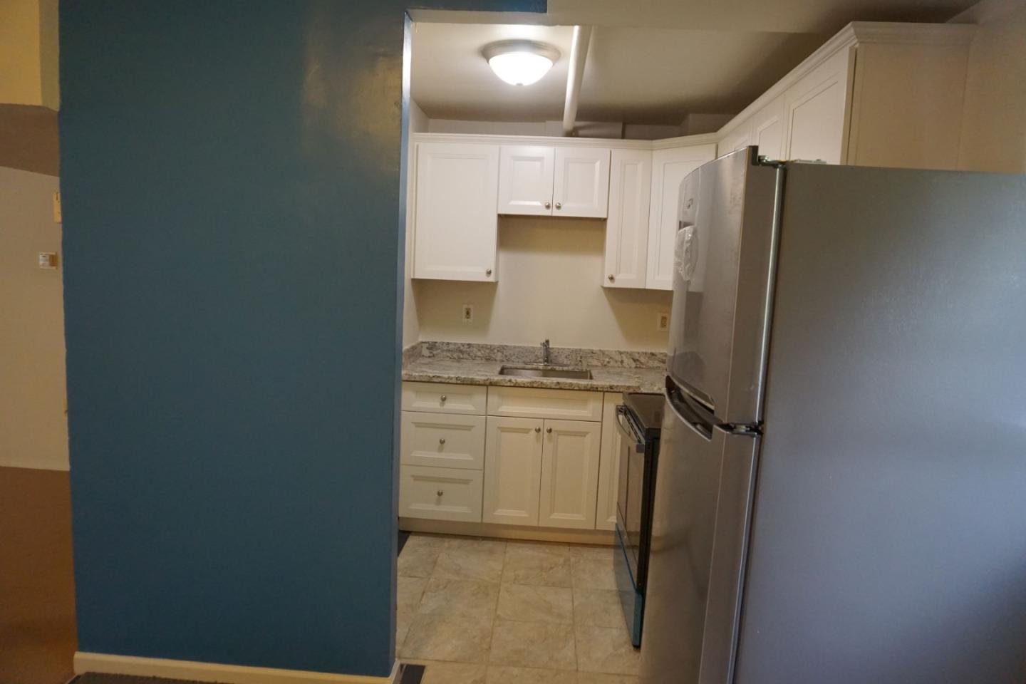 3090 Longview Drive San Bruno, CA 94066 - Photo 19 of 23 a kitchen with a refrigerator and white cabinets