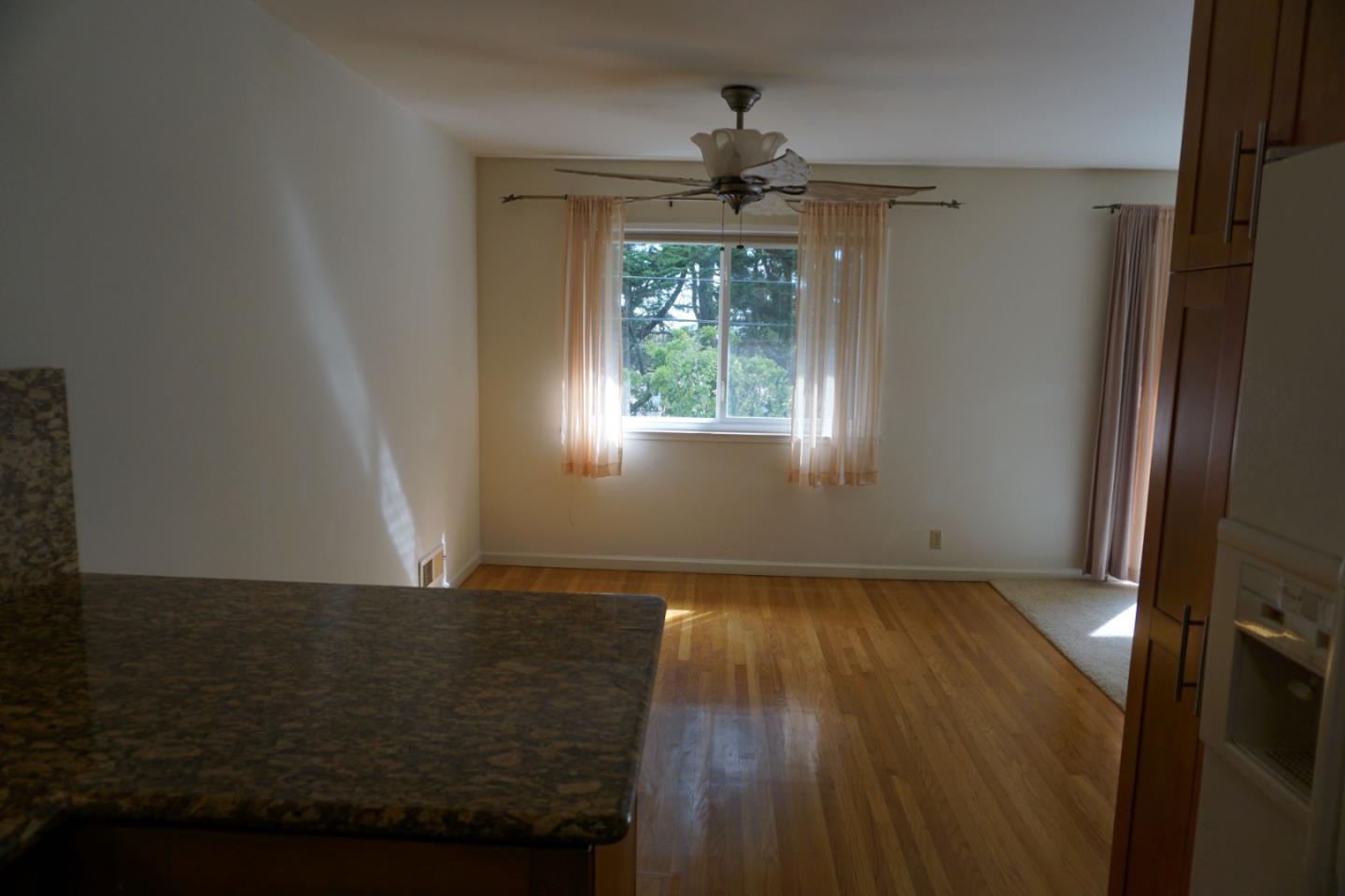 3090 Longview Drive San Bruno, CA 94066 - Photo 7 of 23 an empty room with wooden floor fan and windows