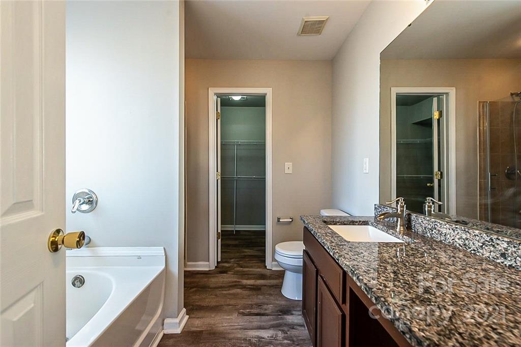 2759 Rustic Ridge Court Rock Hill, SC 29730 - Photo 15 of 19 a bathroom with a granite countertop sink and a bathtub