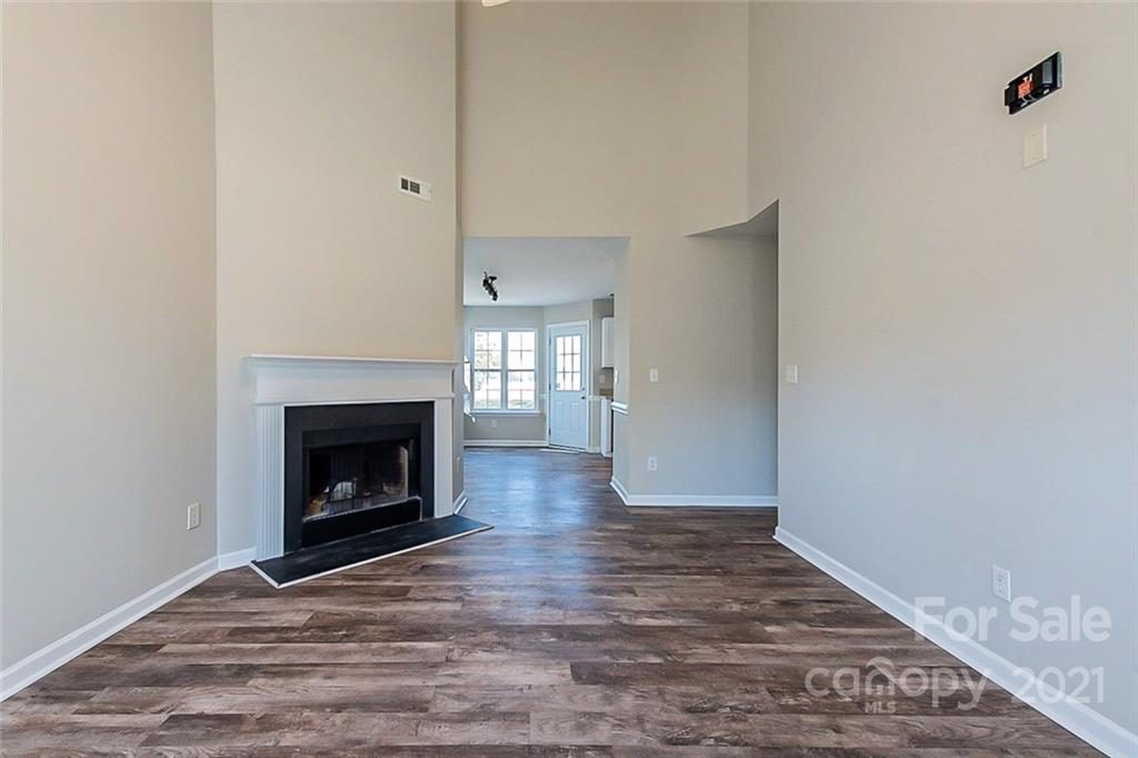 2759 Rustic Ridge Court Rock Hill, SC 29730 - Photo 3 of 19 a view of an empty room with wooden floor fireplace and a window