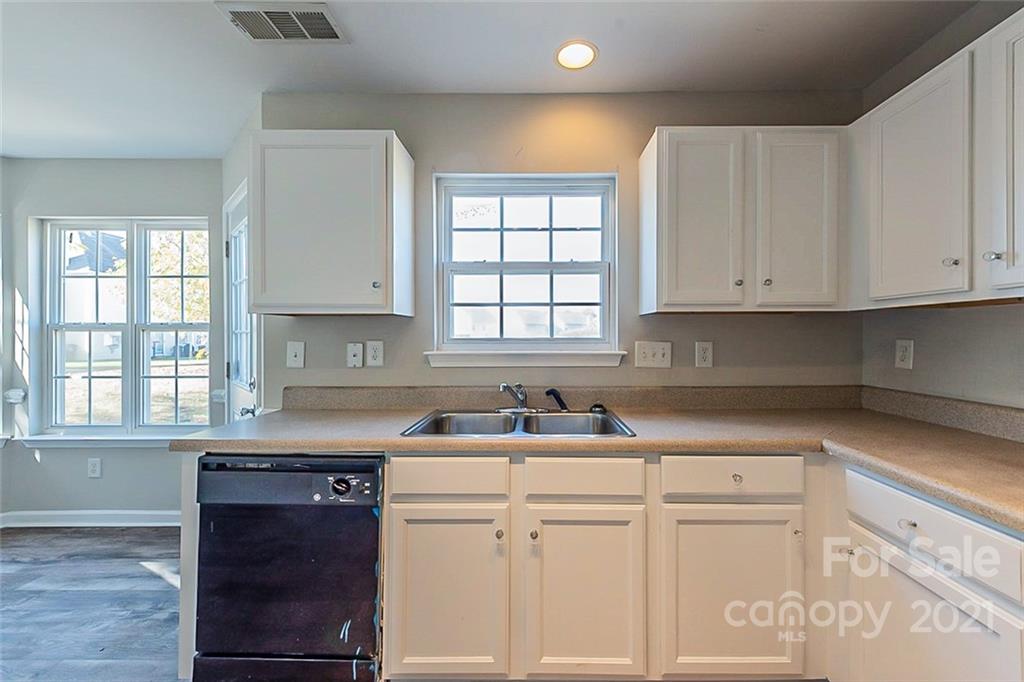 2759 Rustic Ridge Court Rock Hill, SC 29730 - Photo 5 of 19 a kitchen with granite countertop white cabinets and white appliances