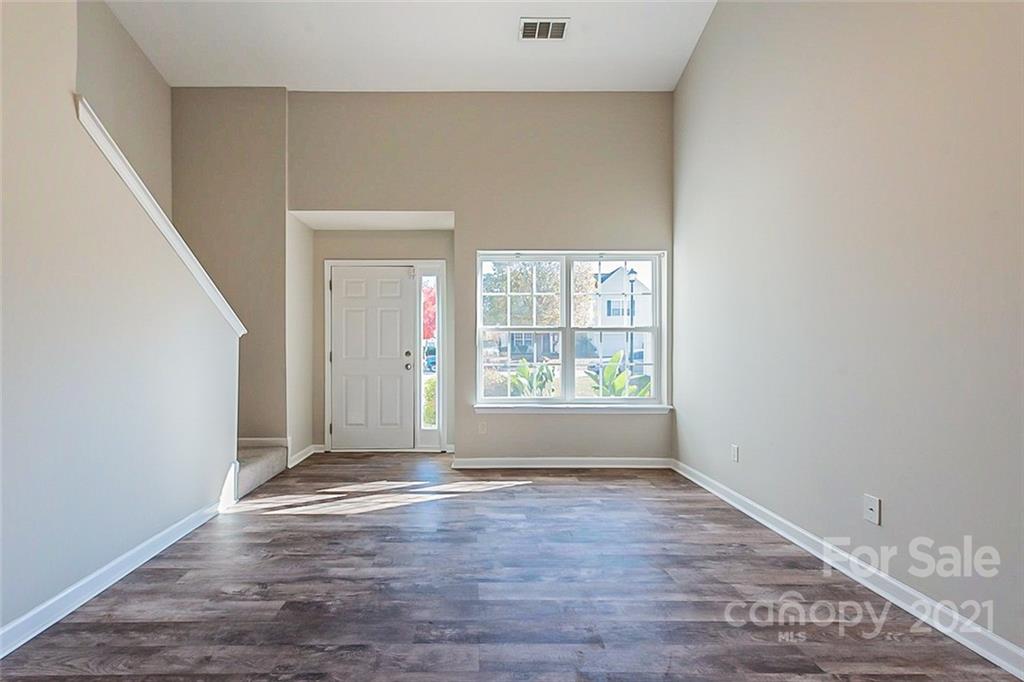 2759 Rustic Ridge Court Rock Hill, SC 29730 - Photo 7 of 19 an empty room with wooden floor and windows