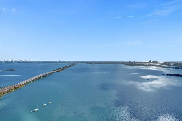 a kitchen with stainless steel appliances kitchen island granite countertop a sink stove and wooden floor