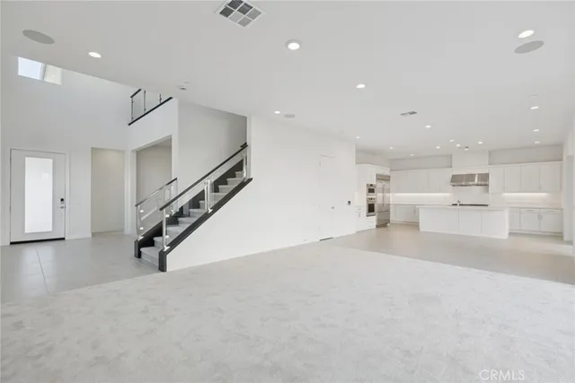 a view of a kitchen with furniture and stairs