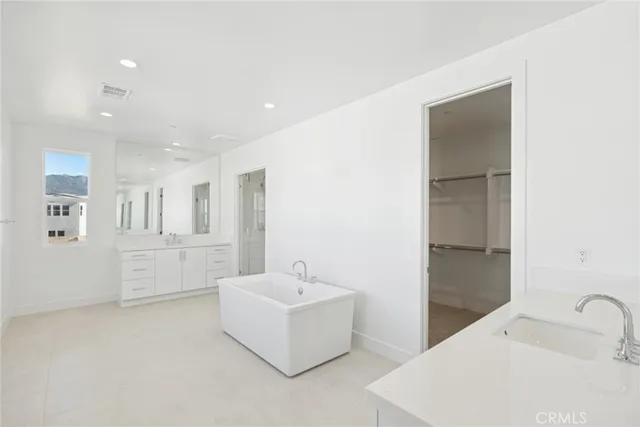 a bathroom with sink shower and mirror