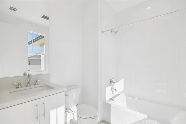 a view of a building with street sign and a tree