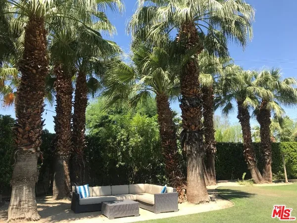 a view of a patio with table and chairs and a fire pit
