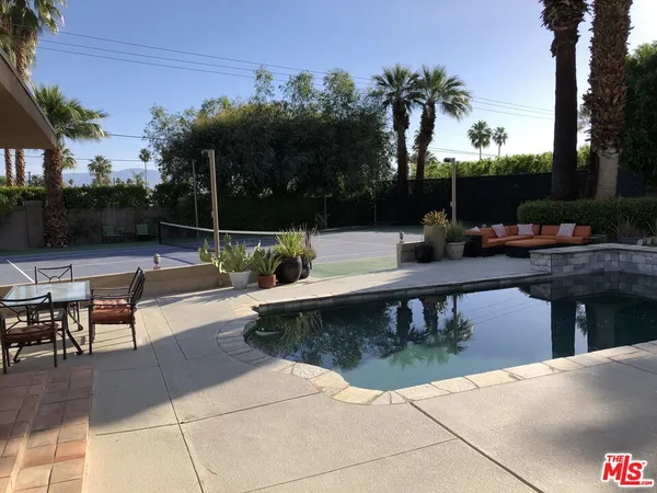 a view of a swimming pool with sitting area
