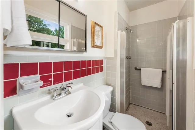 a bathroom with a sink toilet and shower