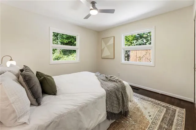 a bed sitting in a bedroom next to a window