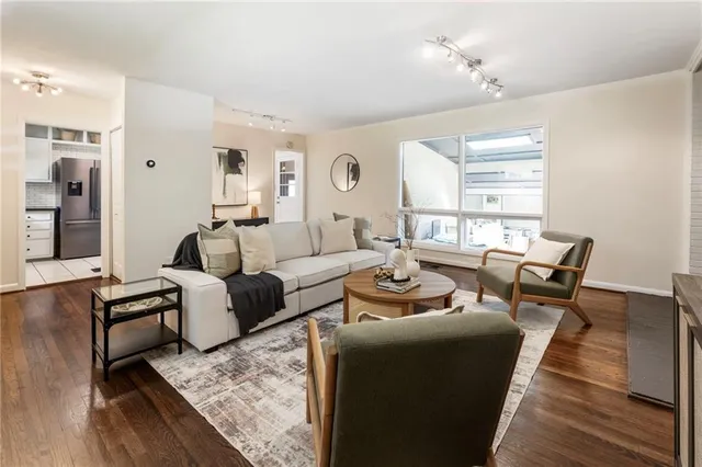a living room with furniture and wooden floor