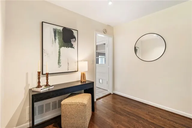 a room with wooden floor and a mirror