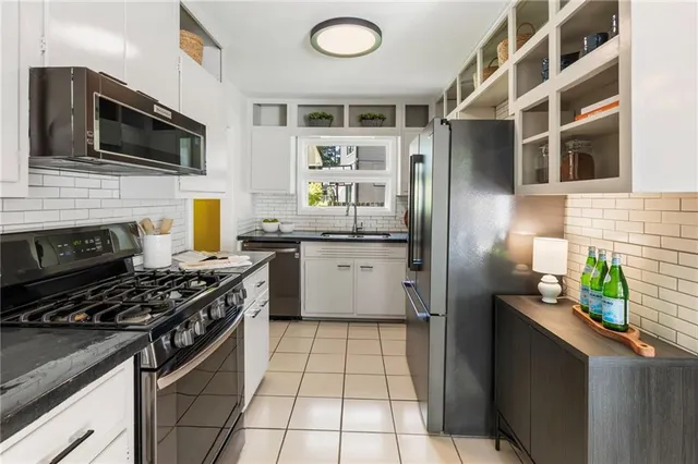 a kitchen with stainless steel appliances granite countertop a stove and a refrigerator