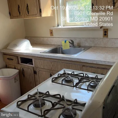 a kitchen with a sink a stove and a window