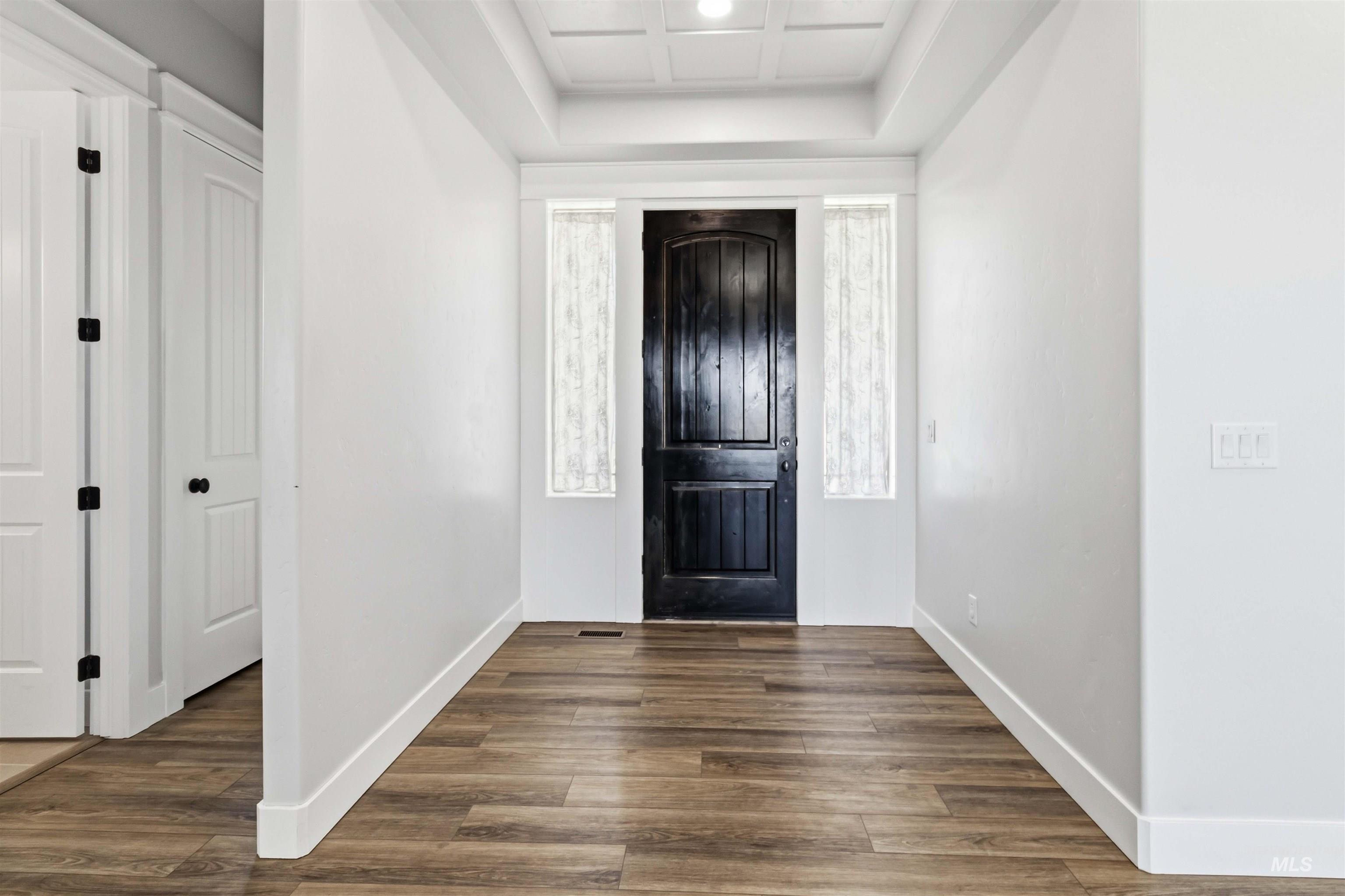 3218 North Cherry Laurel Way Star, ID 83669 - Photo 6 of 50 Open-concept living space with wood-finish flooring, a stone-clad fireplace, and a ceiling fan