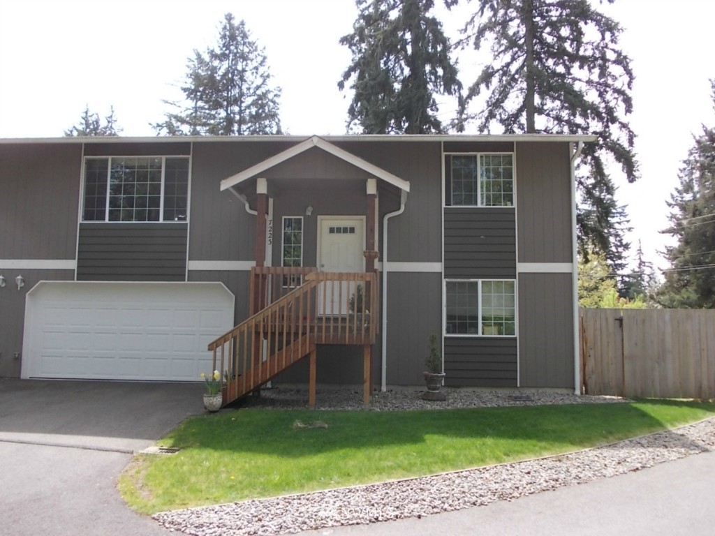 7235 Vandermark Road East Bonney Lake, WA 98391 - Photo 2 of 11 a front view of a house with a yard