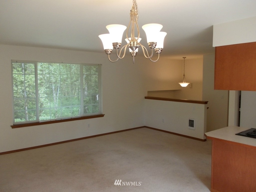 7235 Vandermark Road East Bonney Lake, WA 98391 - Photo 5 of 11 a view of a room with a chandelier