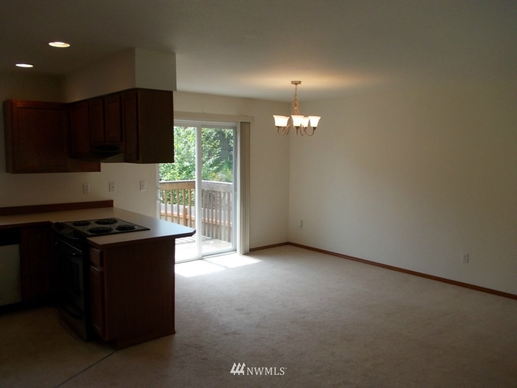 7235 Vandermark Road East Bonney Lake, WA 98391 - Photo 6 of 11 an empty room with kitchen view