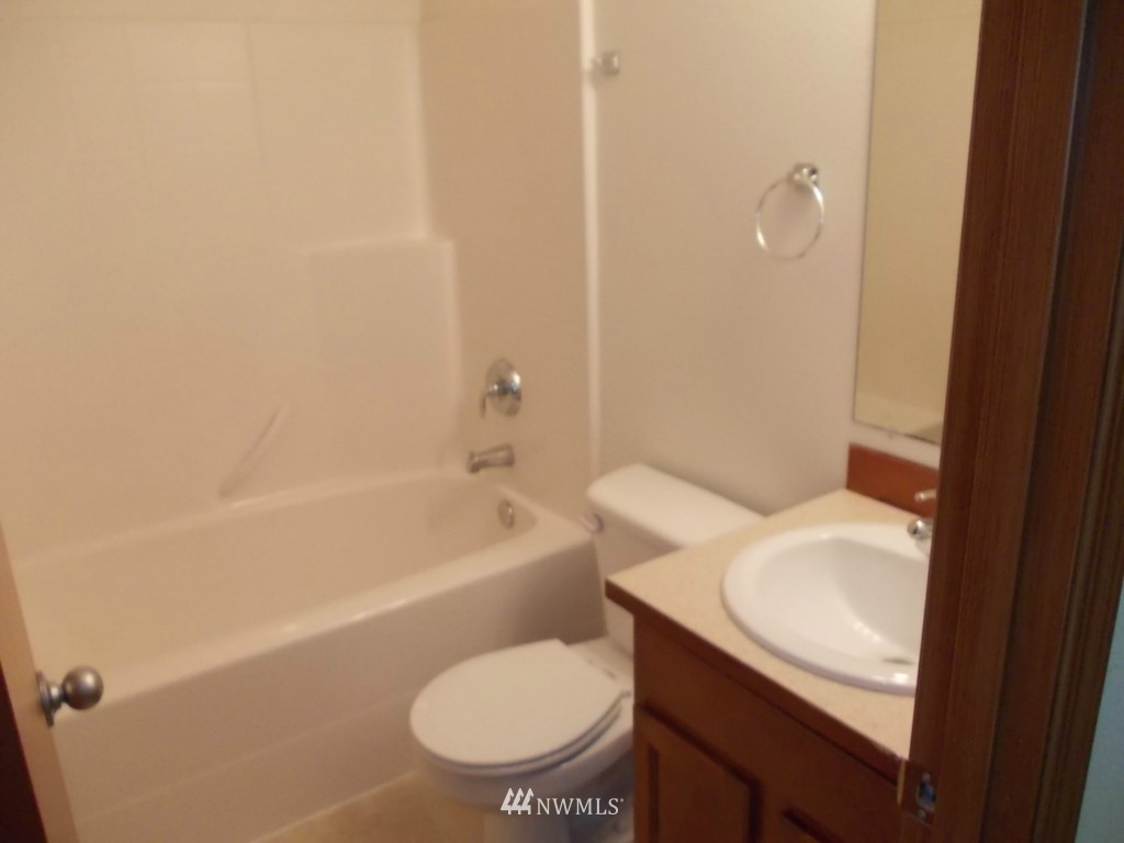 7235 Vandermark Road East Bonney Lake, WA 98391 - Photo 8 of 11 a bathroom with a sink toilet and bathtub