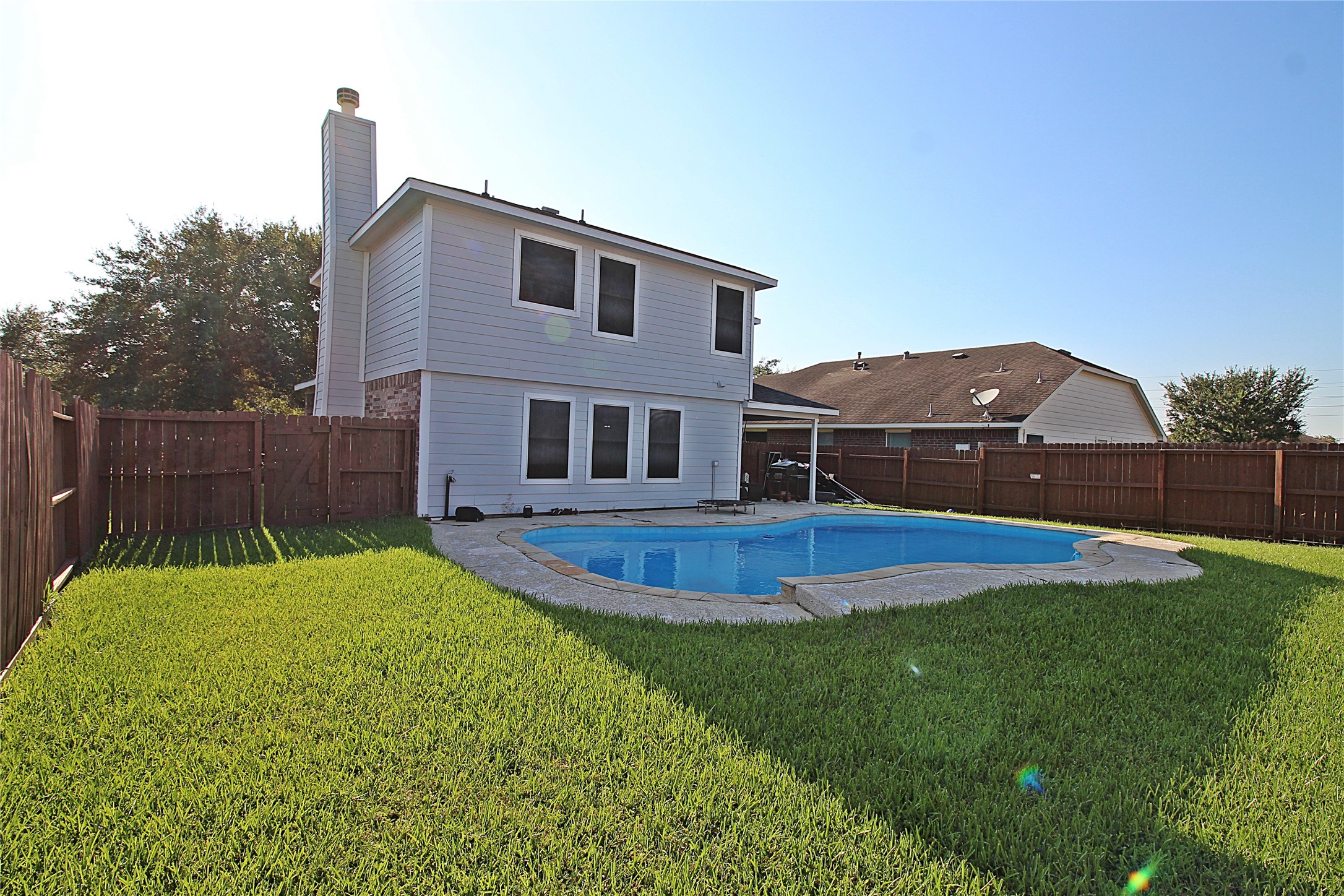 8314 Silver Fir Lane Baytown, TX 77523 - Photo 21 of 22 a view of a house with a yard and sitting area