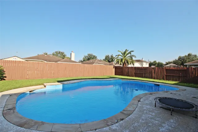 a view of a swimming pool with an outdoor seating